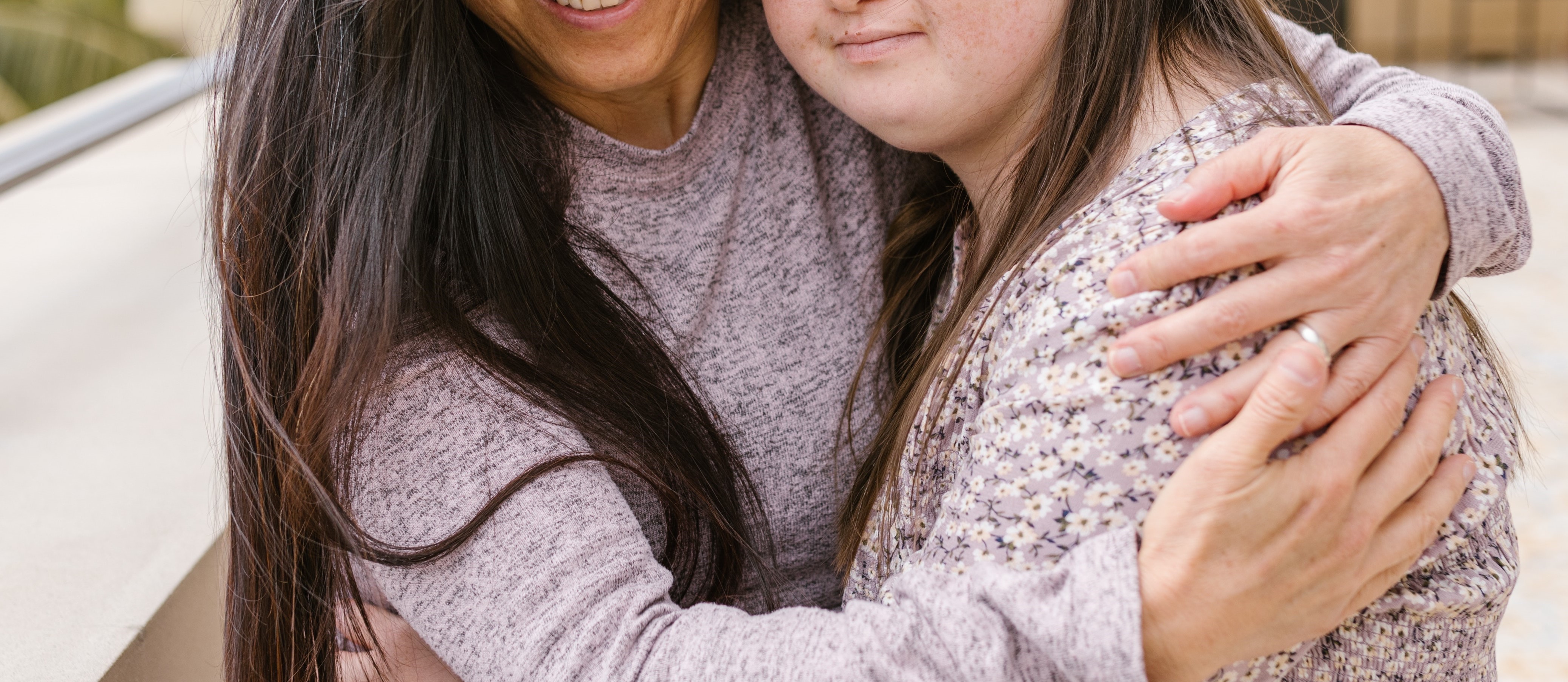 Woman hugging autistic girl