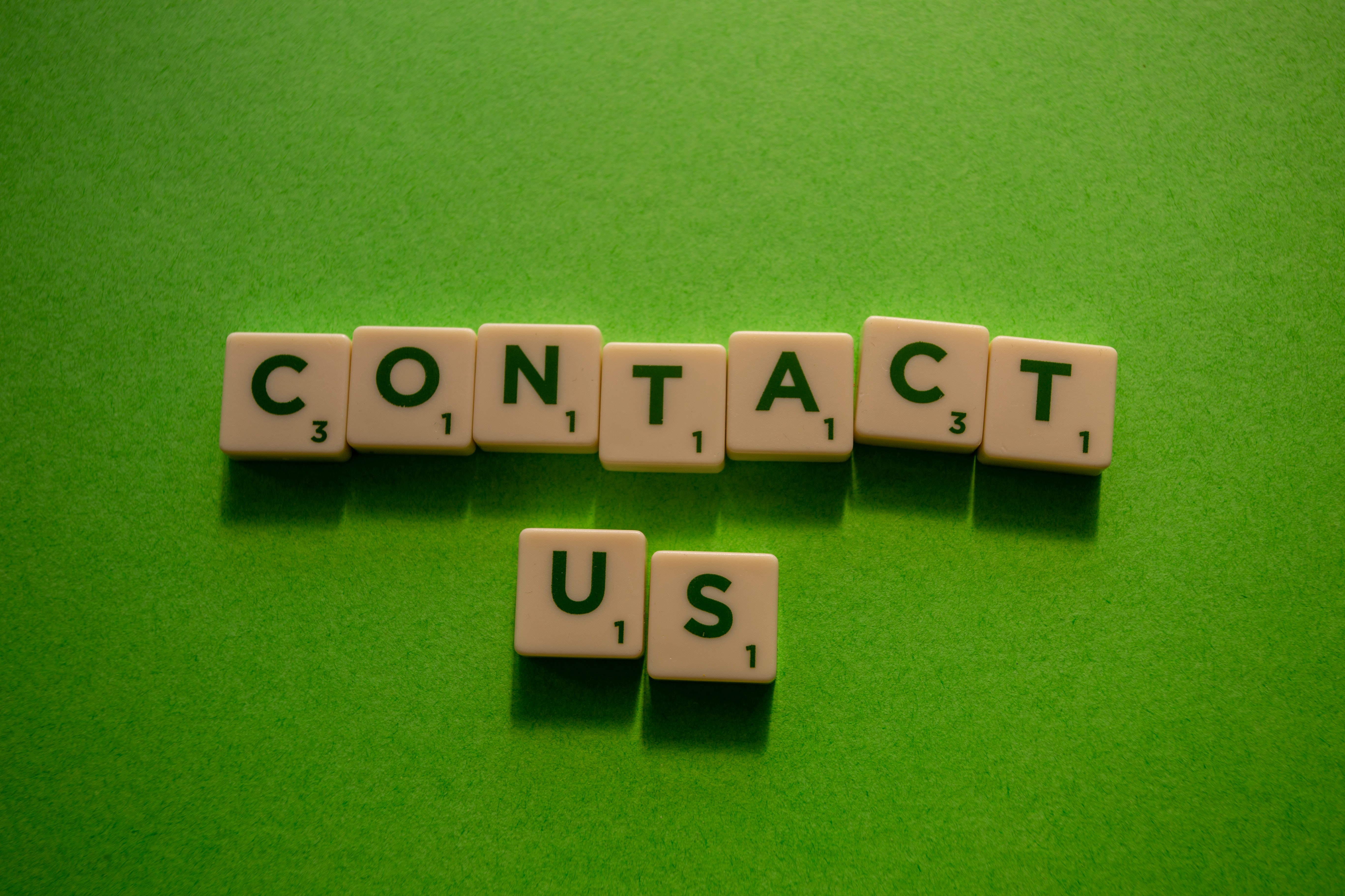 Scrabble letters making the word 'Contact Us'